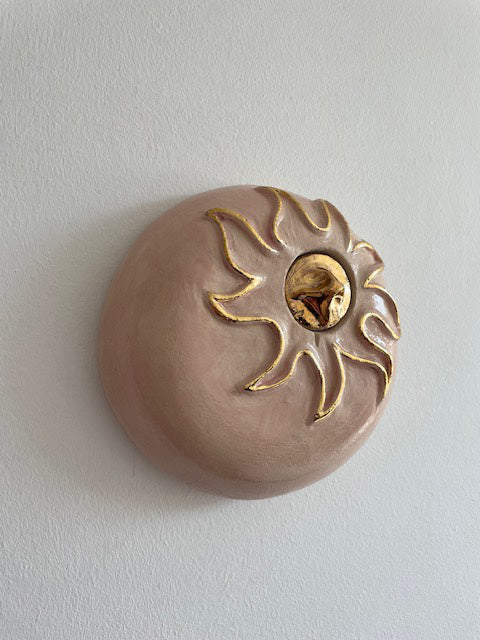Handcrafted soft pink ceramic mini angel urn with 24-carat gold details, suitable for wall mounting