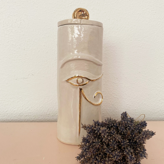 Unique artisan cremation urn in offwhite with golden details in Egyptian style