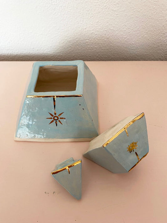 Handcrafted ceramic pyramid urn in blue and gold.
