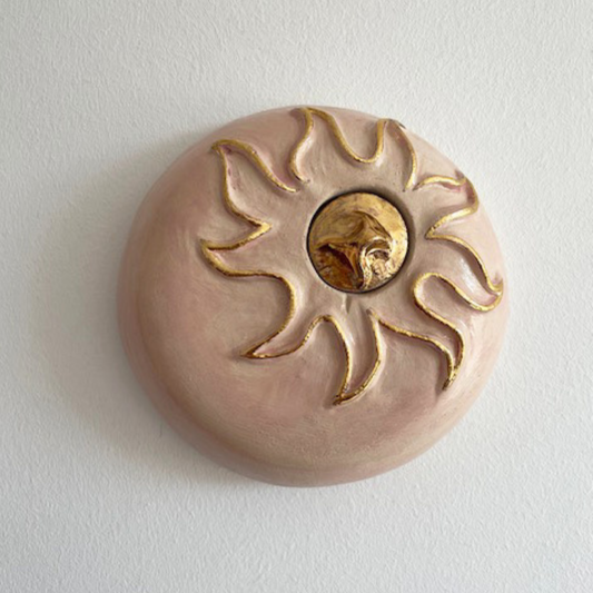 Handcrafted soft pink ceramic mini angel urn with 24-carat gold details, suitable for wall mounting